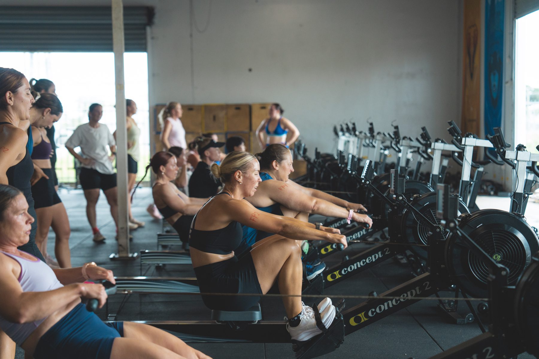 Class on the rowers with a coach leading